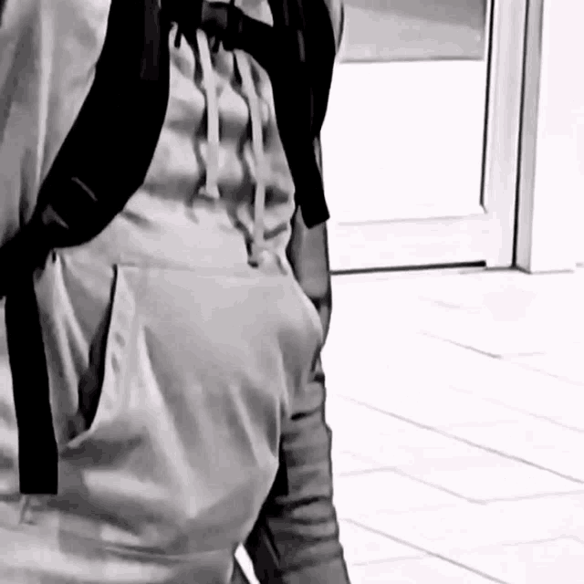 a black and white photo of a person with a backpack on their back