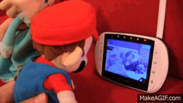 a baby monitor with mario on the screen and makeagif.com at the bottom
