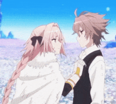 a boy and a girl are standing next to each other in a field