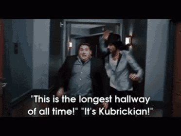 two men are running down a hallway with the caption " this is the longest hallway of all time ! "