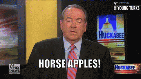 a man in a suit and tie is talking about horse apples