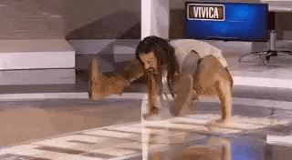 a man with dreadlocks is doing push ups on a glass floor .