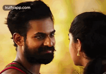 a man with a beard and a woman looking at each other