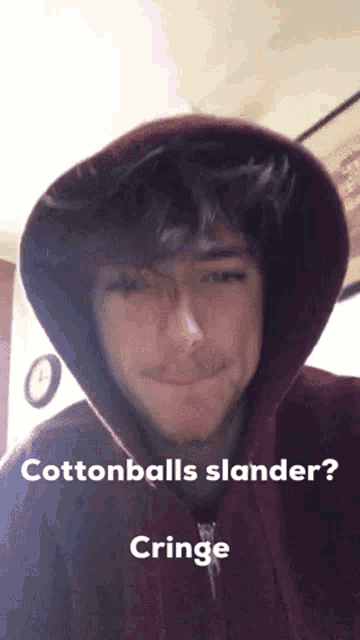 a man wearing a hoodie with the words `` cottonballs slander '' written on it .