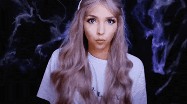 a woman with long purple hair is wearing a white t-shirt that says " i " on it