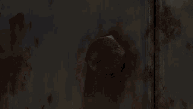 a close up of a rusty metal door with a bolt in it .