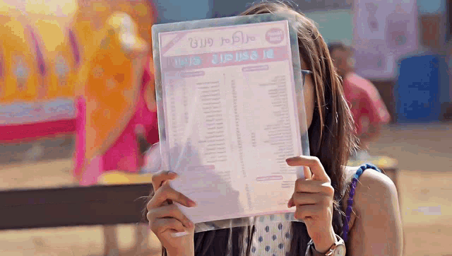 a woman is holding a menu in front of her face that says ' burgers ' on it