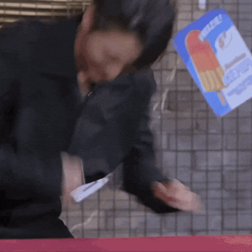 a man in a suit is standing next to a sign that says ' ice cream ' on it