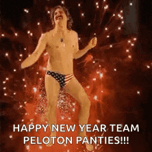 a man in underwear is dancing in front of a fireworks display .