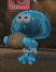 a blue cartoon character is holding a bottle of water .