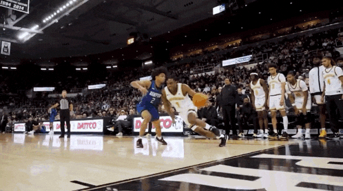 a basketball game is being played in a stadium with a banner that says ' 1998-2014 ' on it