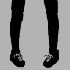 a black and white silhouette of a person 's legs with white shoes .
