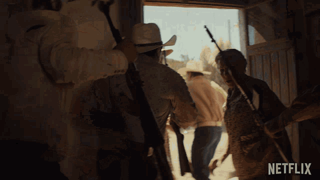 a group of people holding guns in front of a sign that says netflix on it