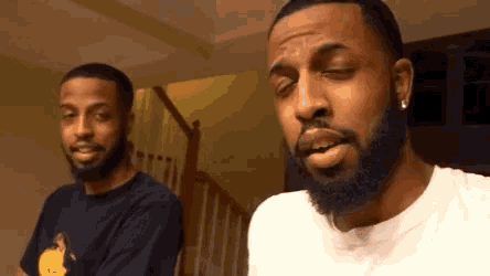 a man with a beard is standing next to another man with a beard