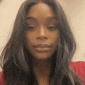 a close up of a woman 's face with long dark hair .
