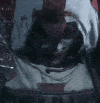 a blurred image of a person with a hood on their head