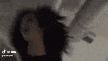 a close up of a person 's face with a blurred background and a tik tok watermark .