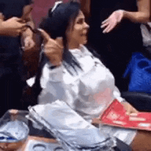 a woman is sitting in a chair getting her hair dyed .