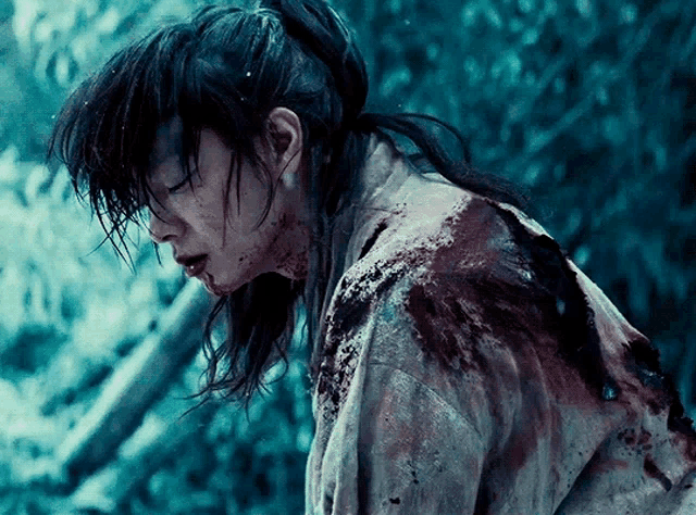 a person with blood on their face and clothes