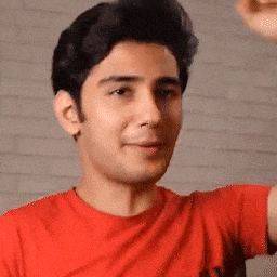 a man in a red t-shirt is flexing his arm