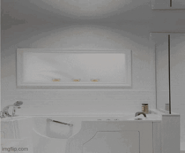 a bathroom with two sinks and a bathtub with images.com written in the corner