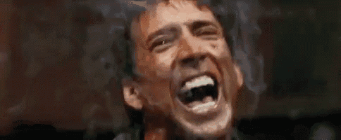 a man is screaming with his mouth open in a close up of his face .