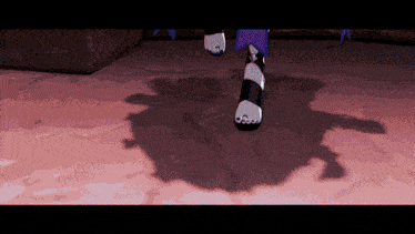 a person 's shadow is cast on a pink surface