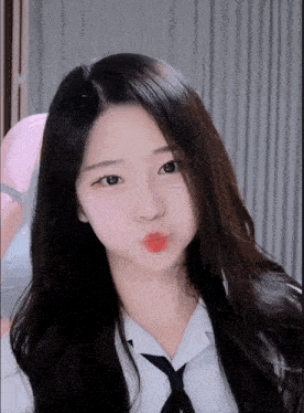 a girl with long hair is making a funny face