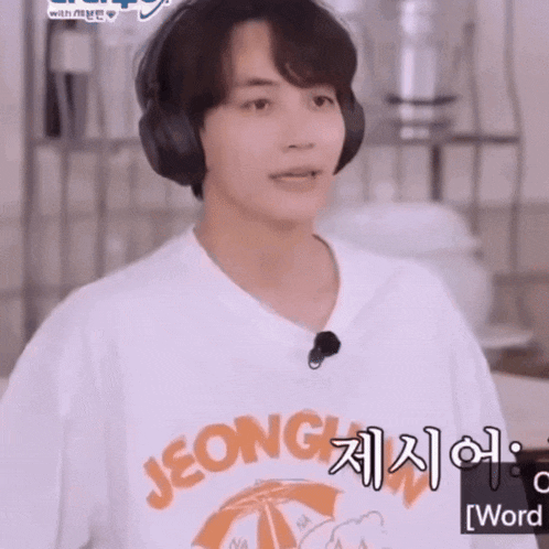 a young man wearing headphones and a white shirt that says jeonghyun