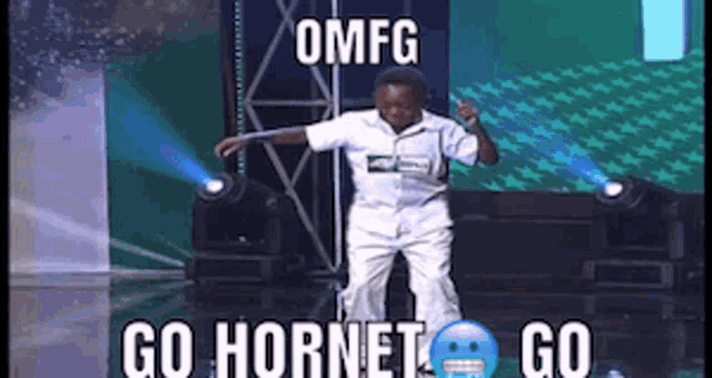 a man is dancing on a stage with the words go hornet go