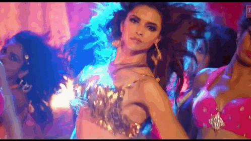 a woman in a pink bra is dancing in a club