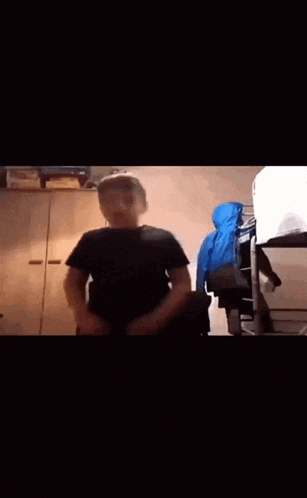 a man is dancing in a room with a bunk bed
