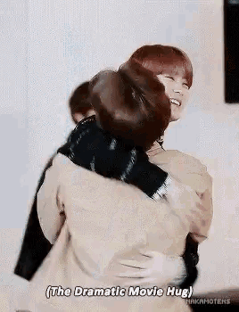 two men are hugging each other in a room and one of them is saying `` the dramatic movie hug '' .