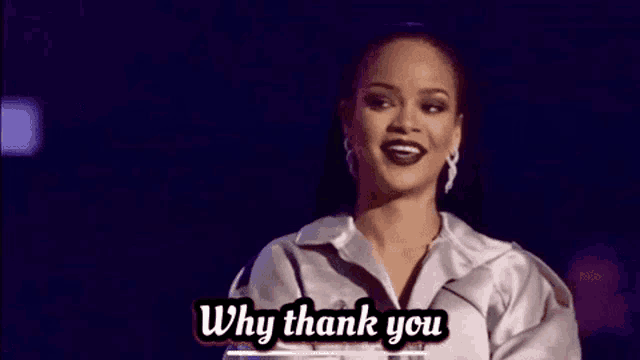 a woman is standing on a stage and saying `` why thank you '' while wearing a white jacket .