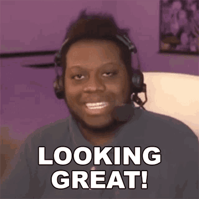 a man wearing headphones and a microphone says `` looking great '' .