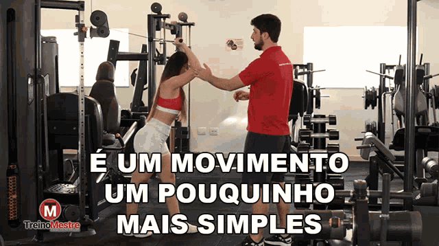 a man in a red shirt is teaching a woman how to do squats