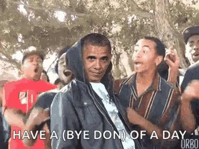 barack obama is wearing a hooded jacket and dancing with a group of men .