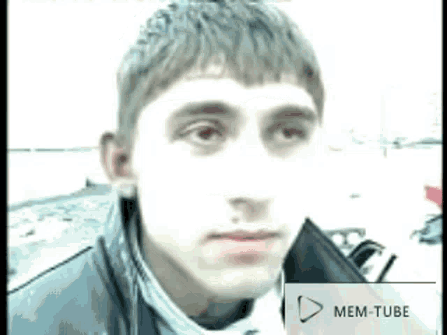 a close up of a man 's face with a mem-tube icon next to him .