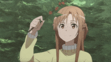 a girl in a yellow sweater holds a branch with red berries on it