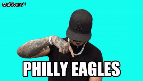 a man flexes his muscles in front of a philly eagles sign