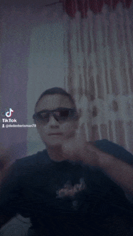 a blurry picture of a man wearing sunglasses and a shirt that says death