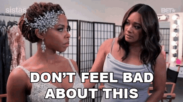 two women are standing next to each other in a room and talking .
