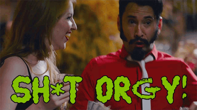 a man in a red shirt and tie is talking to a woman with the words " sh * t orgy " written in green