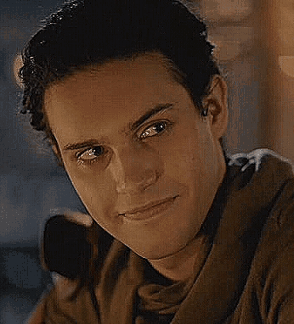 a close up of a man 's face with a smile on it .