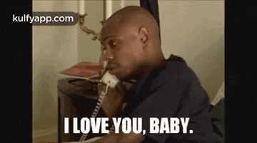 a man is talking on a phone and saying `` i love you , baby . ''