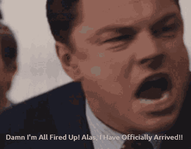 a man in a suit and tie is saying damn i 'm all fired up