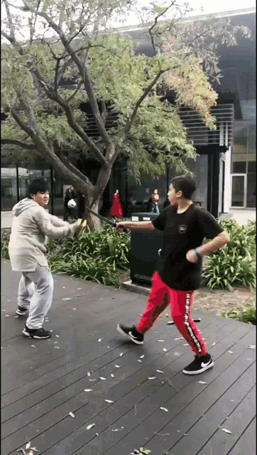 a man wearing red pants with the word supreme on them