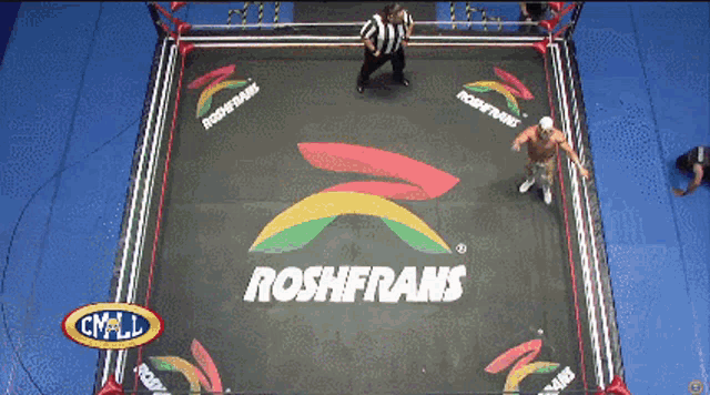 a wrestling ring with a logo for roshfrans on the floor