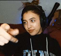 a woman wearing headphones and a black shirt that says titan