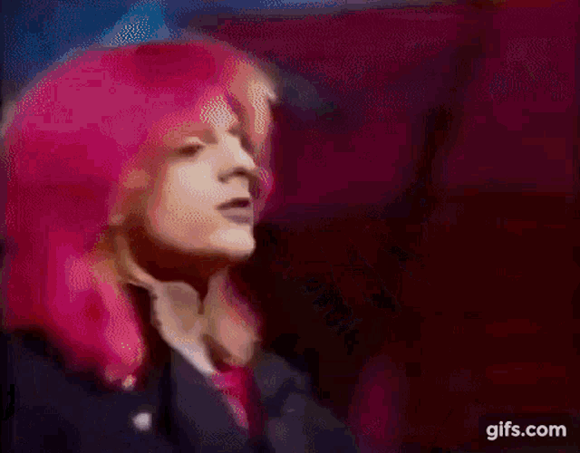 a close up of a person playing a guitar on a stage .